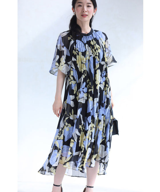 A sheer floral mid-length dress with pleats that flares out from the neck