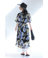 A sheer floral mid-length dress with pleats that flares out from the neck