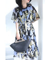 A sheer floral mid-length dress with pleats that flares out from the neck