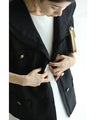 Traditional jacket with gold buttons and a sailor collar and shoulder pads