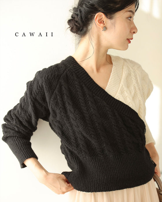 A knit pullover top with a black and white cache-coeur design
