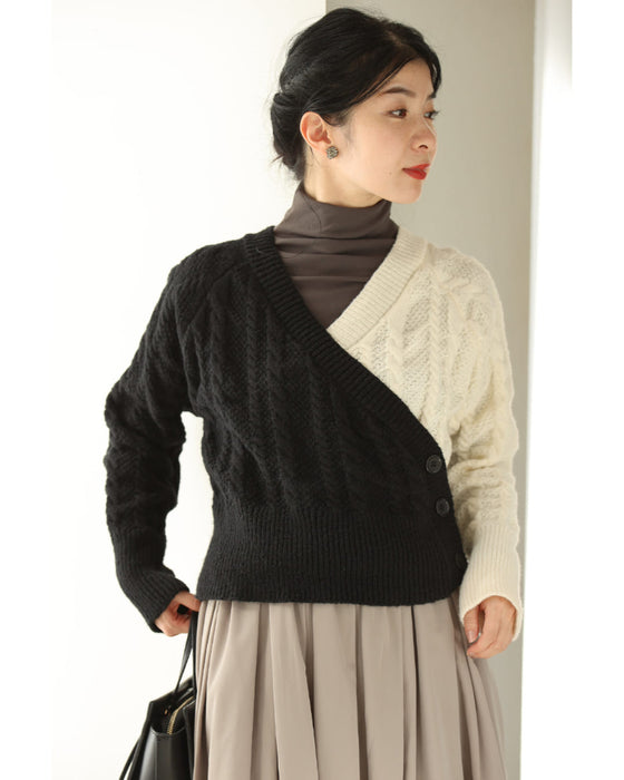 A knit pullover top with a black and white cache-coeur design