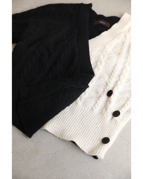 A knit pullover top with a black and white cache-coeur design