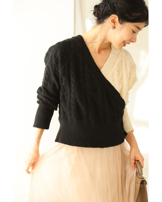 A knit pullover top with a black and white cache-coeur design