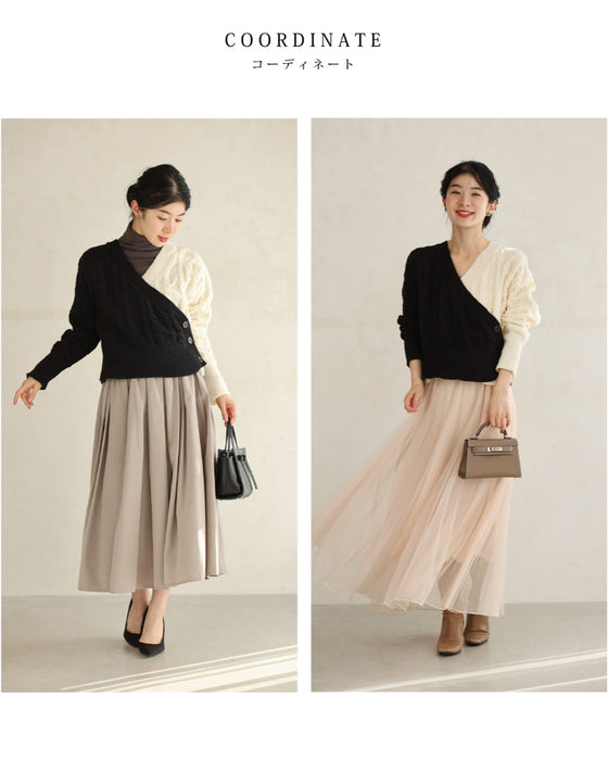 A knit pullover top with a black and white cache-coeur design