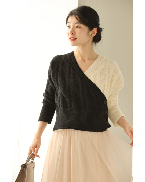 A knit pullover top with a black and white cache-coeur design