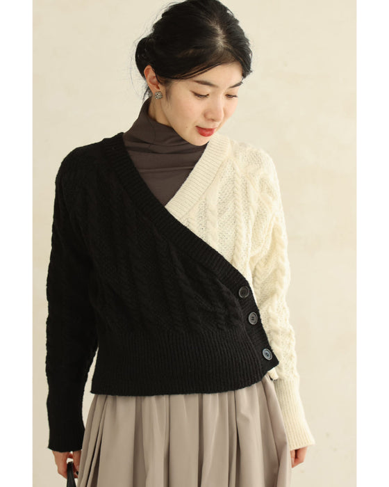 A knit pullover top with a black and white cache-coeur design