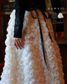 A voluminous bouquet skirt wrapped in rose flowers