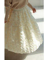 A voluminous bouquet skirt wrapped in rose flowers
