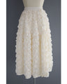 A voluminous bouquet skirt wrapped in rose flowers