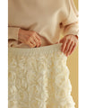 A voluminous bouquet skirt wrapped in rose flowers