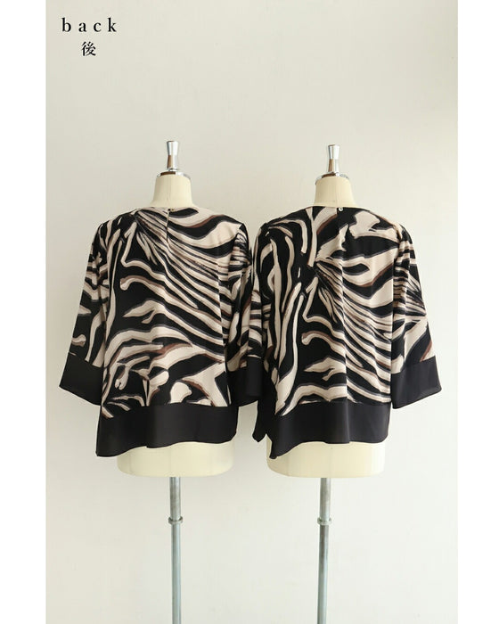 流れゆくアート柄のモードブラウストップス