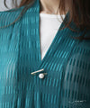 A subtle and elegant accent with a jewel and pearl pin brooch
