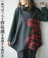 Wrapped in a cozy knit, this top features an eye-catching artistic pattern all around. 