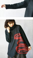 Wrapped in a cozy knit, this top features an eye-catching artistic pattern all around. 