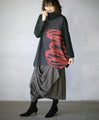 Wrapped in a cozy knit, this top features an eye-catching artistic pattern all around. 