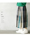 A voluminous tuck skirt with a striking large check pattern