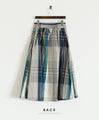 A voluminous tuck skirt with a striking large check pattern
