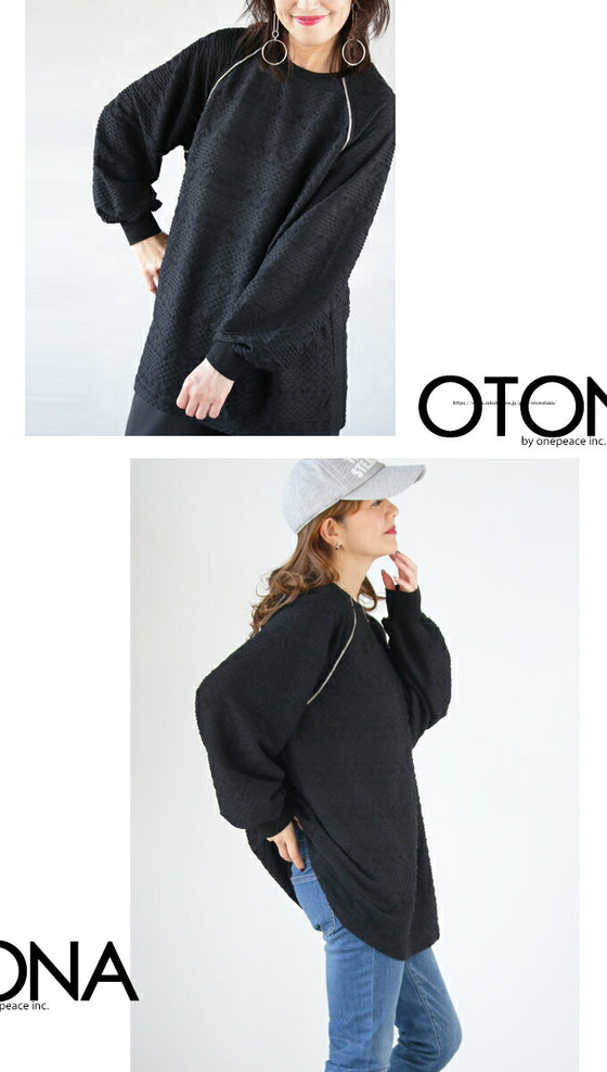 A knit top with a subtle piping logo and a raised fabric