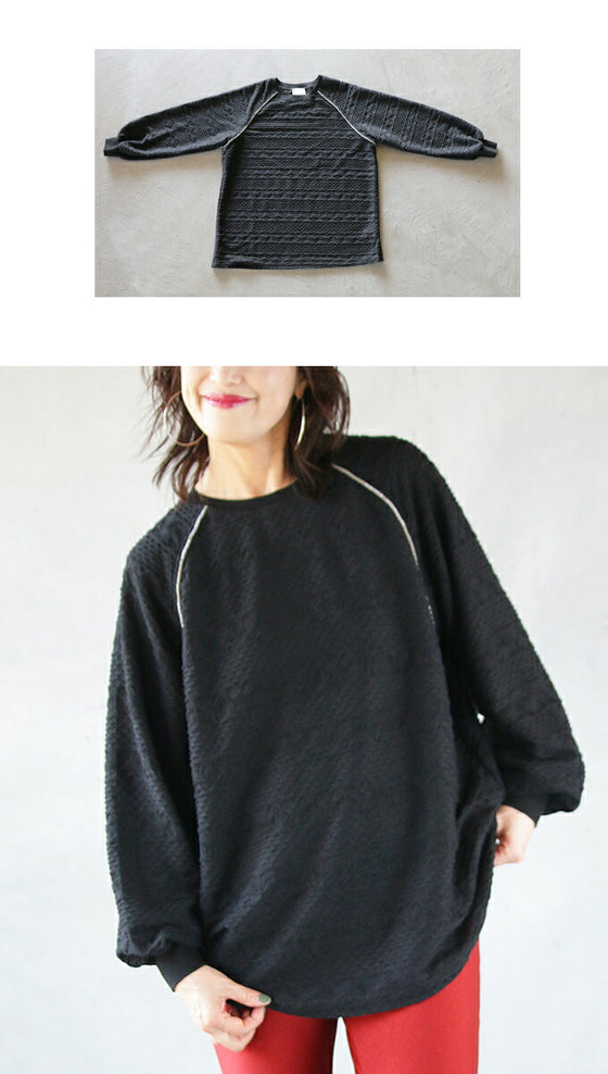 A knit top with a subtle piping logo and a raised fabric