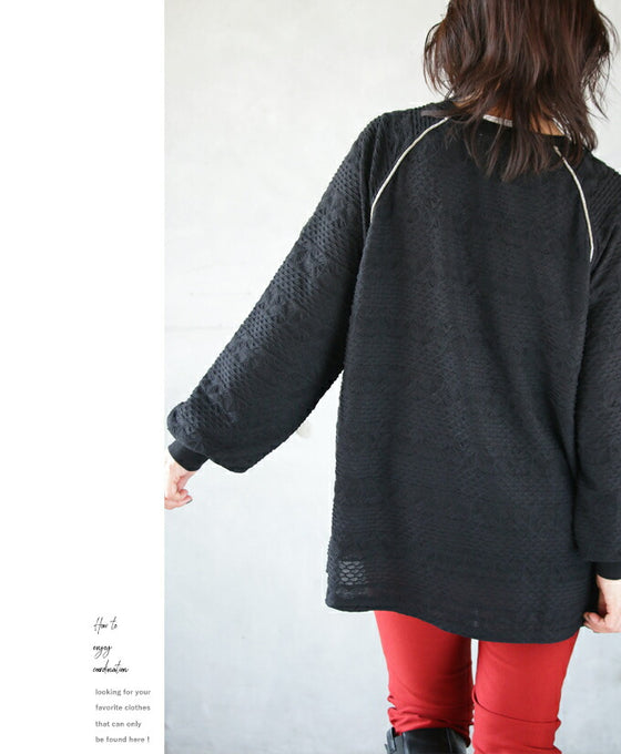 A knit top with a subtle piping logo and a raised fabric