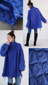 A warm combination of different materials. Royal blue stands out against the cold sky.