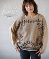 A knit top with a motif pattern that stands out naturally