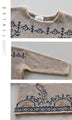 A knit top with a motif pattern that stands out naturally