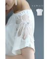 A cut-and-sew top with shimmering beads and light drops