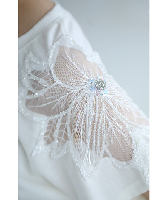 A cut-and-sew top with shimmering beads and light drops