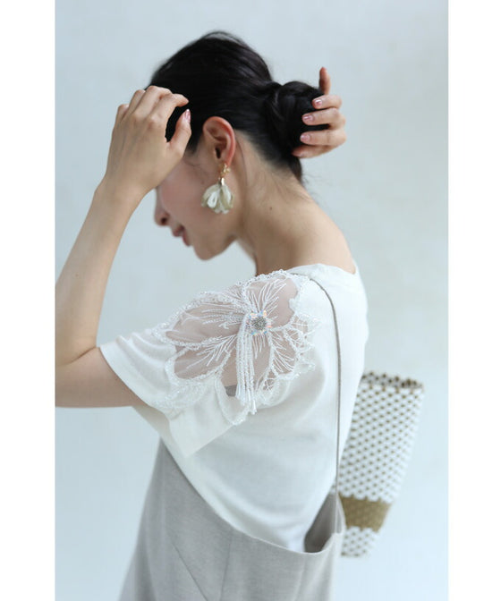 A cut-and-sew top with shimmering beads and light drops