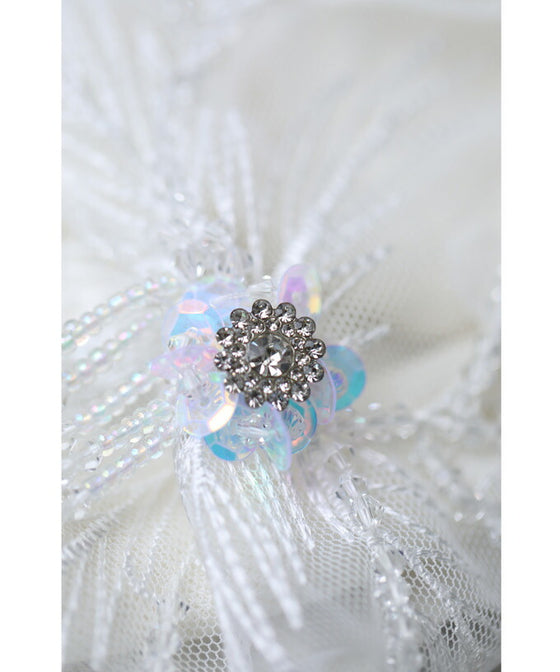 A cut-and-sew top with shimmering beads and light drops