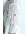 A cut-and-sew top with shimmering beads and light drops