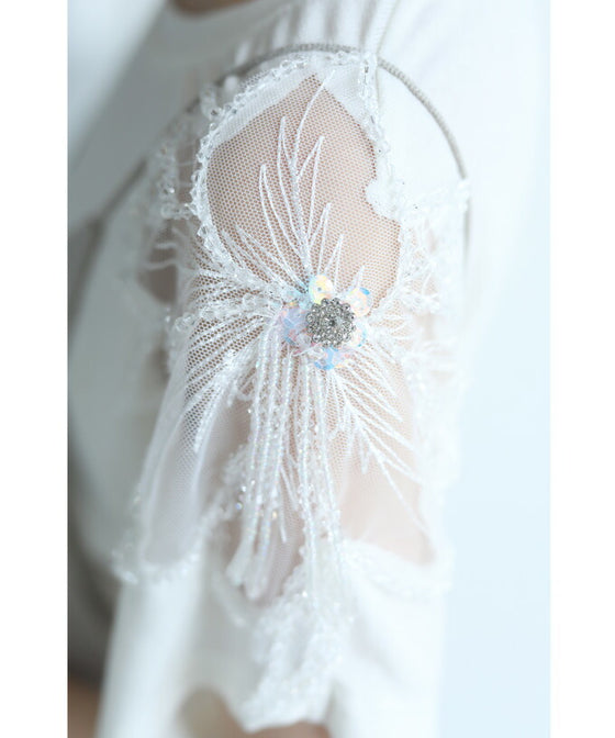 A cut-and-sew top with shimmering beads and light drops