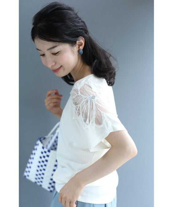 A cut-and-sew top with shimmering beads and light drops