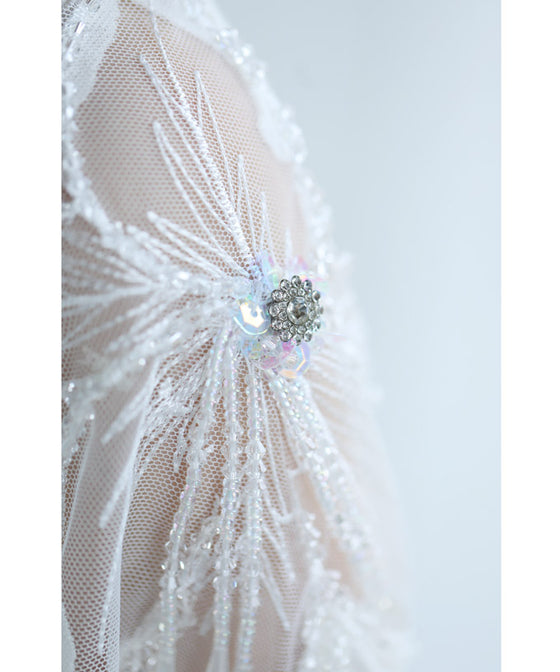 A cut-and-sew top with shimmering beads and light drops