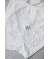 A cut-and-sew top with shimmering beads and light drops
