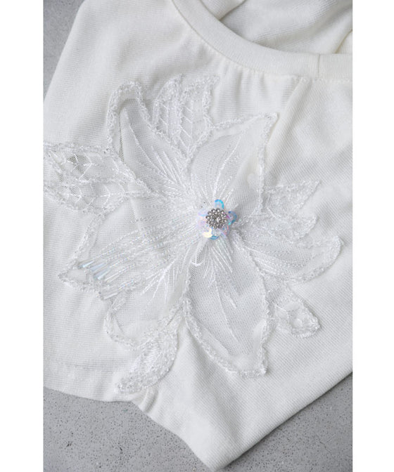 A cut-and-sew top with shimmering beads and light drops