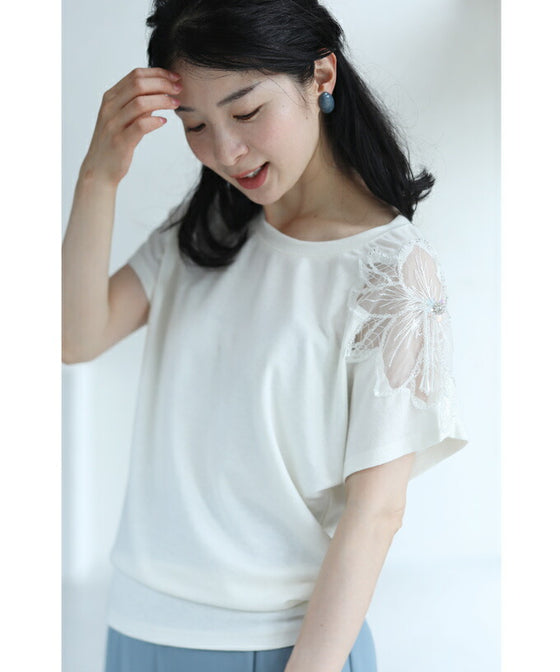 A cut-and-sew top with shimmering beads and light drops