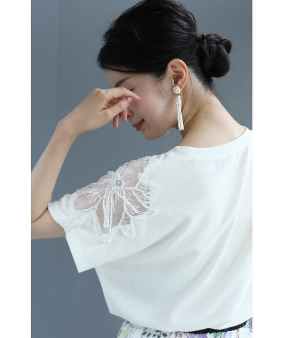A cut-and-sew top with shimmering beads and light drops