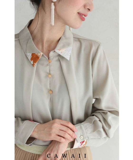 首から流れるタックのポイントアートブラウストップス