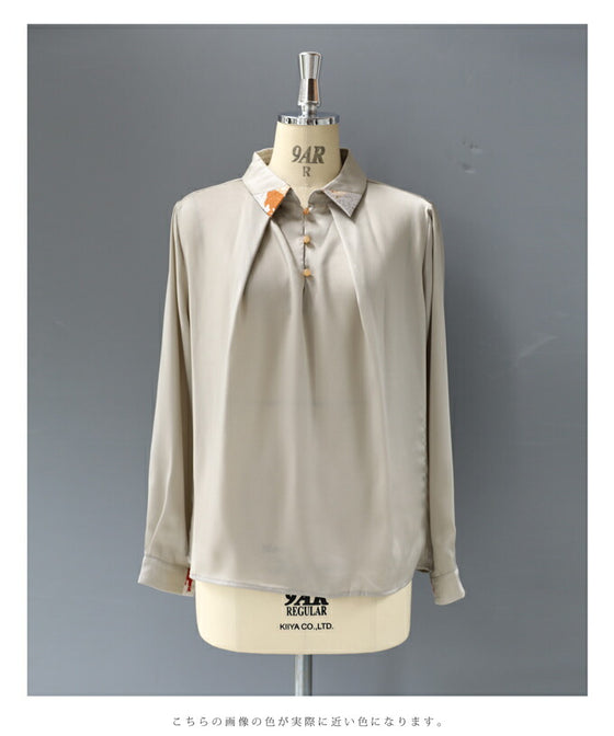 首から流れるタックのポイントアートブラウストップス