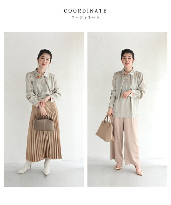 首から流れるタックのポイントアートブラウストップス