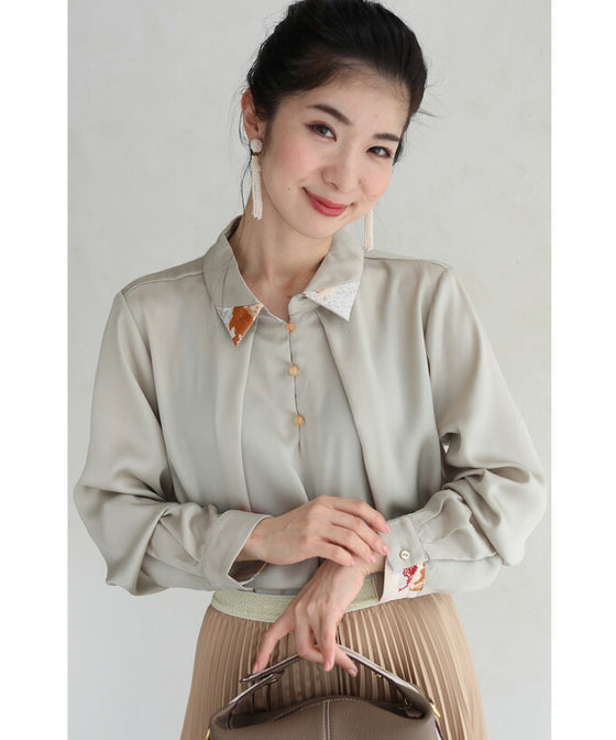 首から流れるタックのポイントアートブラウストップス