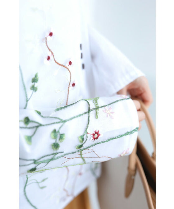 Asymmetrical blouse top with floral embroidery on tulle