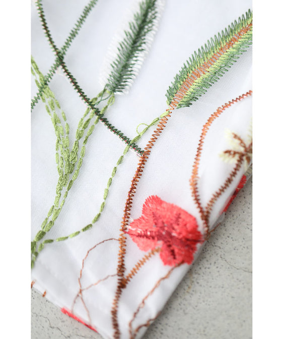 Asymmetrical blouse top with floral embroidery on tulle