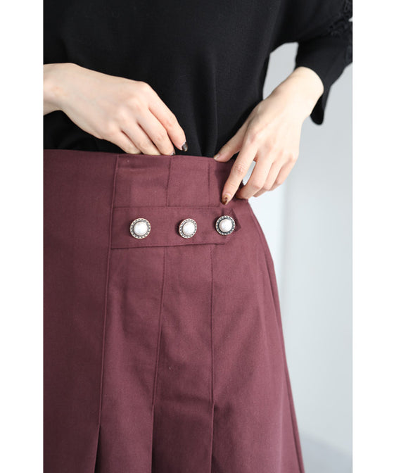 パールボタン連なるアシンメトリープリーツミディアムスカート