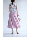 A pleated midi skirt with a fluttering design