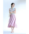 A pleated midi skirt with a fluttering design